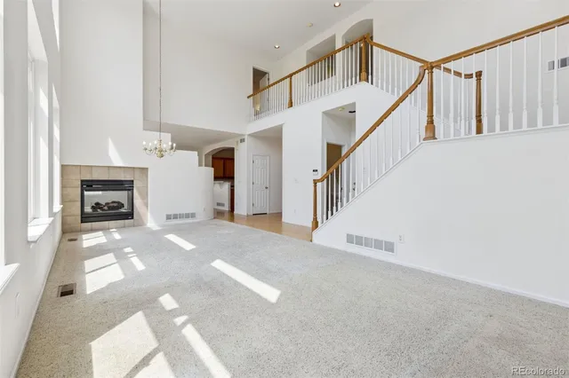 a view of entryway and hall with a fireplace