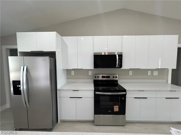 a kitchen with cabinets and stainless steel appliances