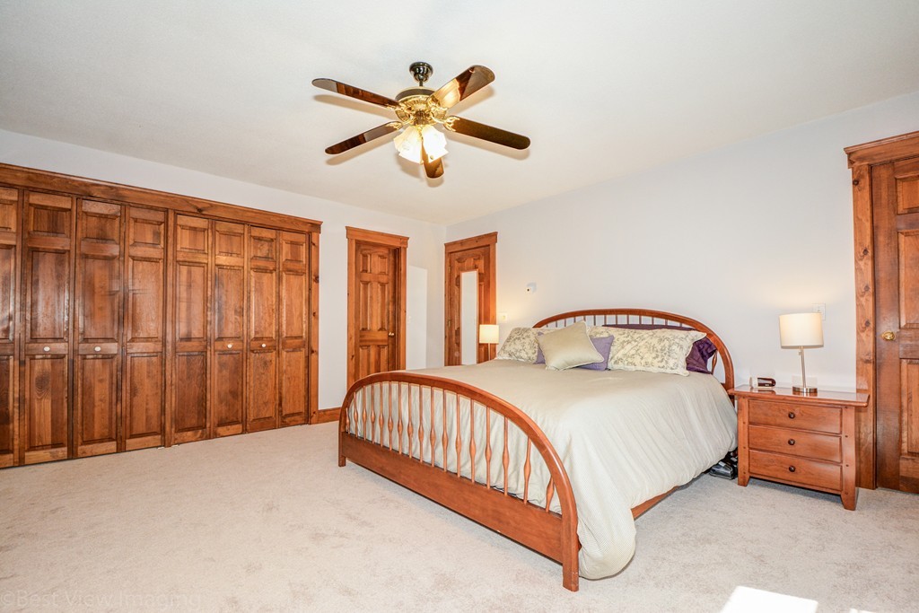 253 New Boston Road Sturbridge, MA 01566 - Photo 13 of 30 a bedroom with a bed and a chandelier