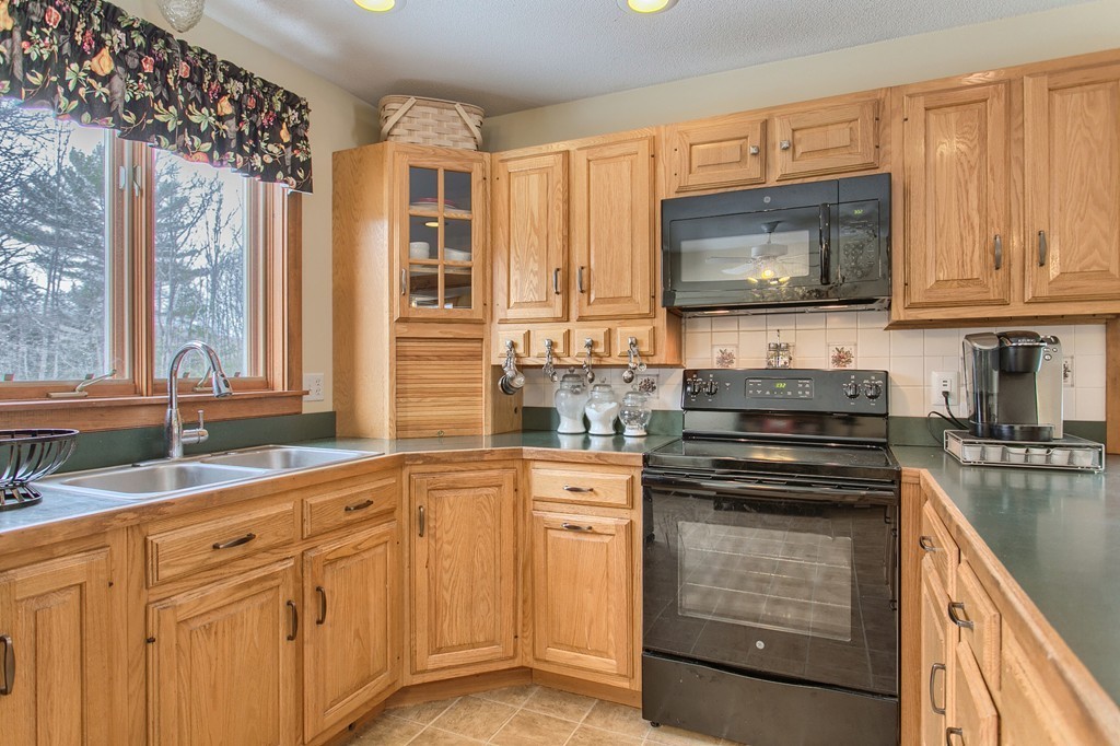 253 New Boston Road Sturbridge, MA 01566 - Photo 5 of 30 a kitchen with stainless steel appliances granite countertop a stove a sink and a microwave