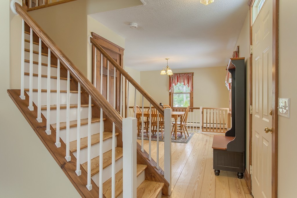 253 New Boston Road Sturbridge, MA 01566 - Photo 6 of 30 a view of staircase with lots of frames on wall and a chandelier