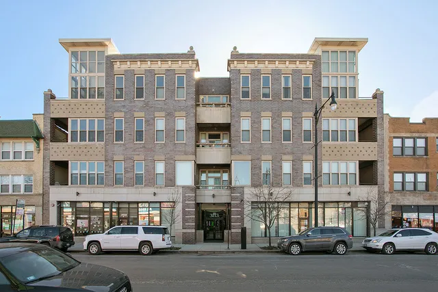 a city street lined with parked cars and buildings