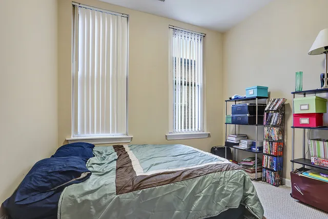 a bedroom with a bed furniture and a book shelf