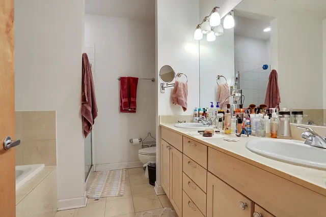 a bathroom with a sink vanity mirror and toilet
