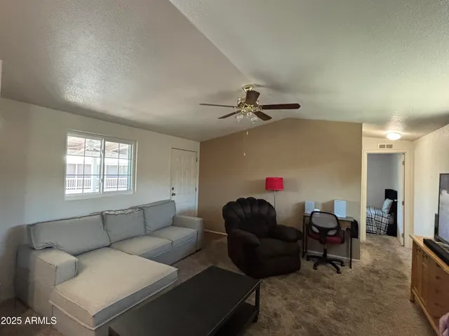 a living room with furniture and a window
