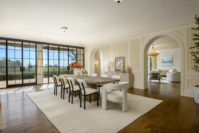 a view of a dining room with furniture wooden floor and chandelier