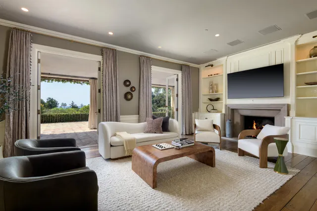 a living room with furniture and a fireplace