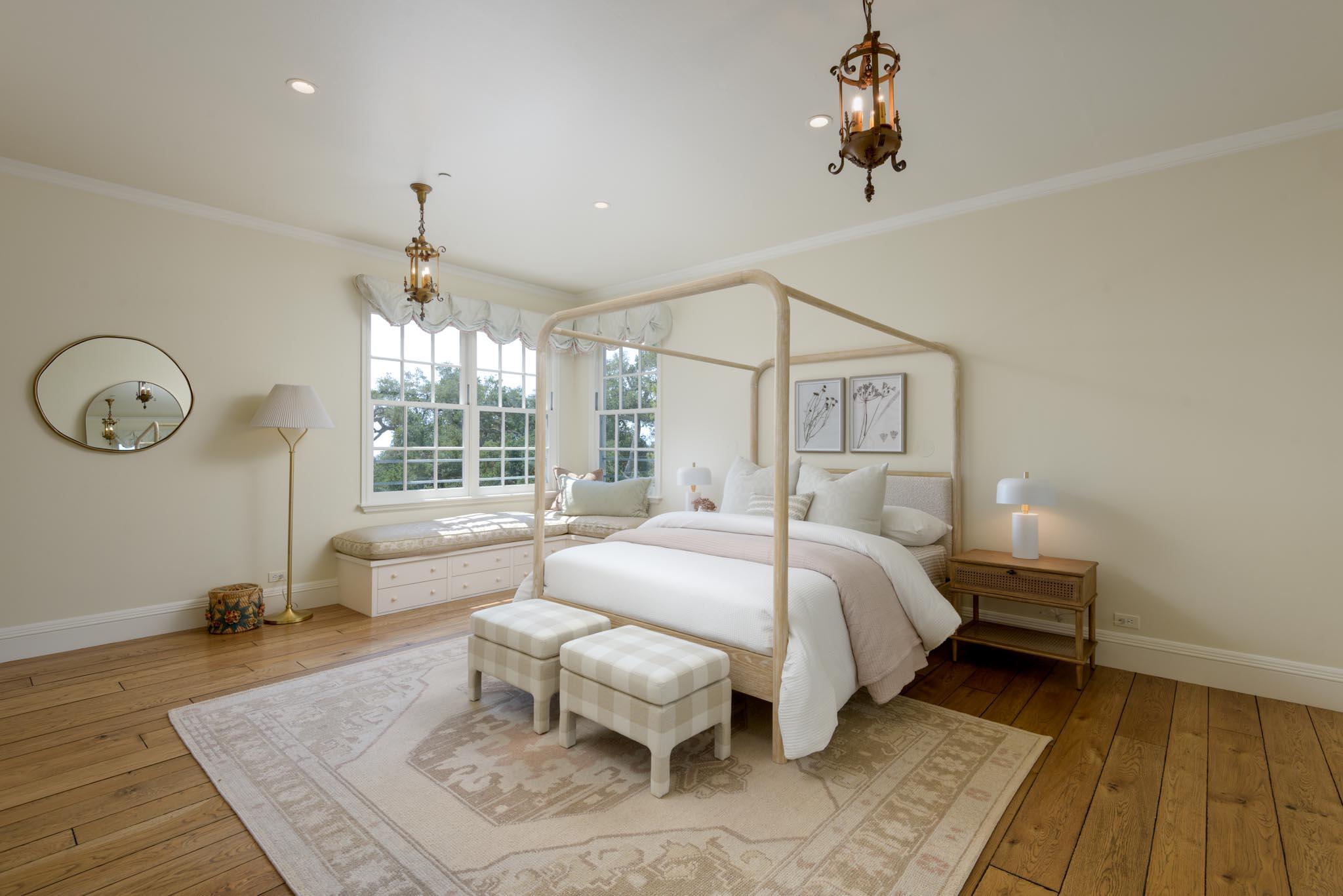 771 Garden Lane Montecito, CA 93108 - Photo 33 of 44 a spacious bedroom with a bed a chandelier and large window