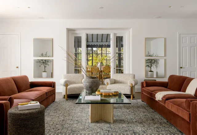 a living room with furniture and large windows