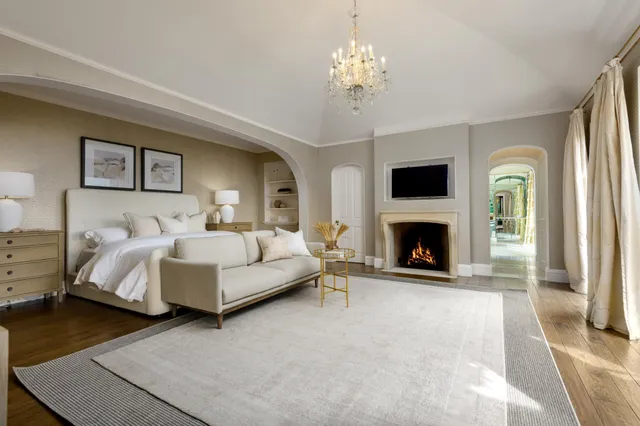 a spacious bedroom with a bed and a fireplace