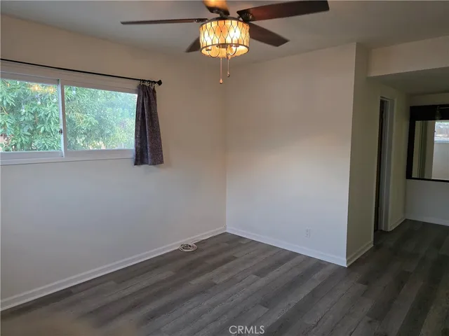 a view of a room with wooden floor and a window