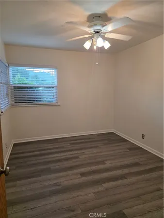 a bathroom with a sink a toilet a window and mirror