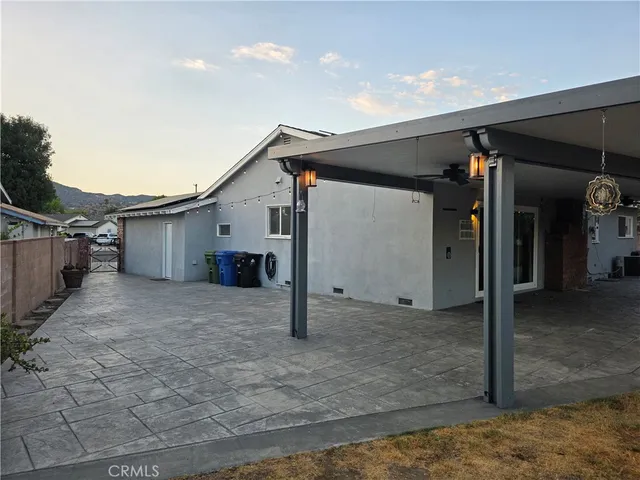 a view of swimming pool with a table and chairs in front of it