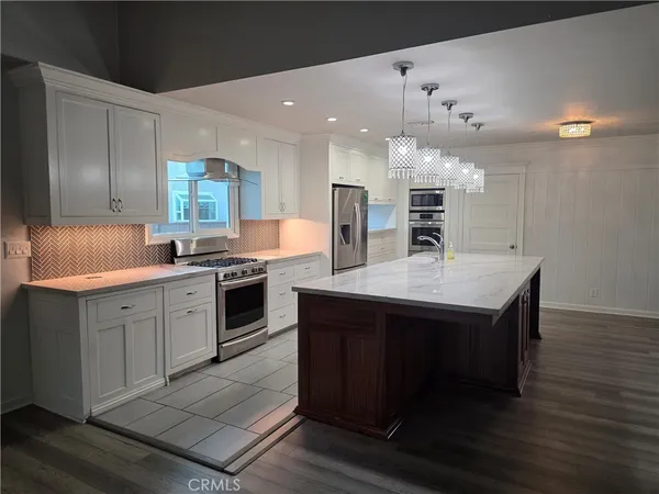 a kitchen with a sink appliances and cabinets