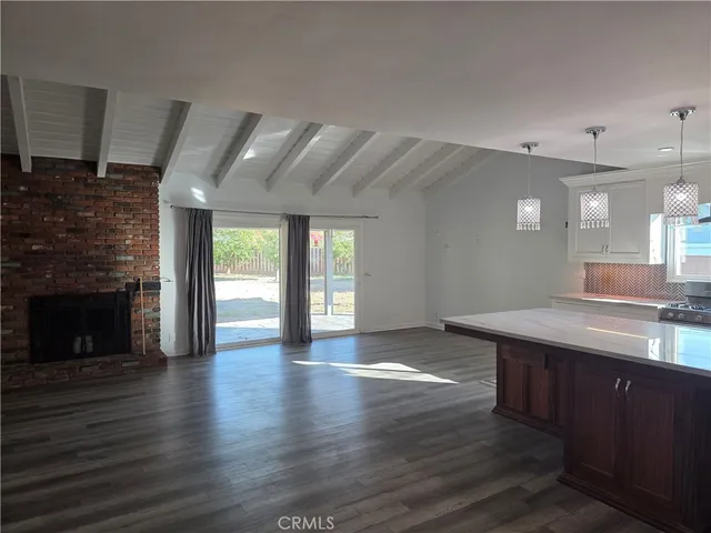 a spacious bathroom with a granite countertop sink and a fireplace