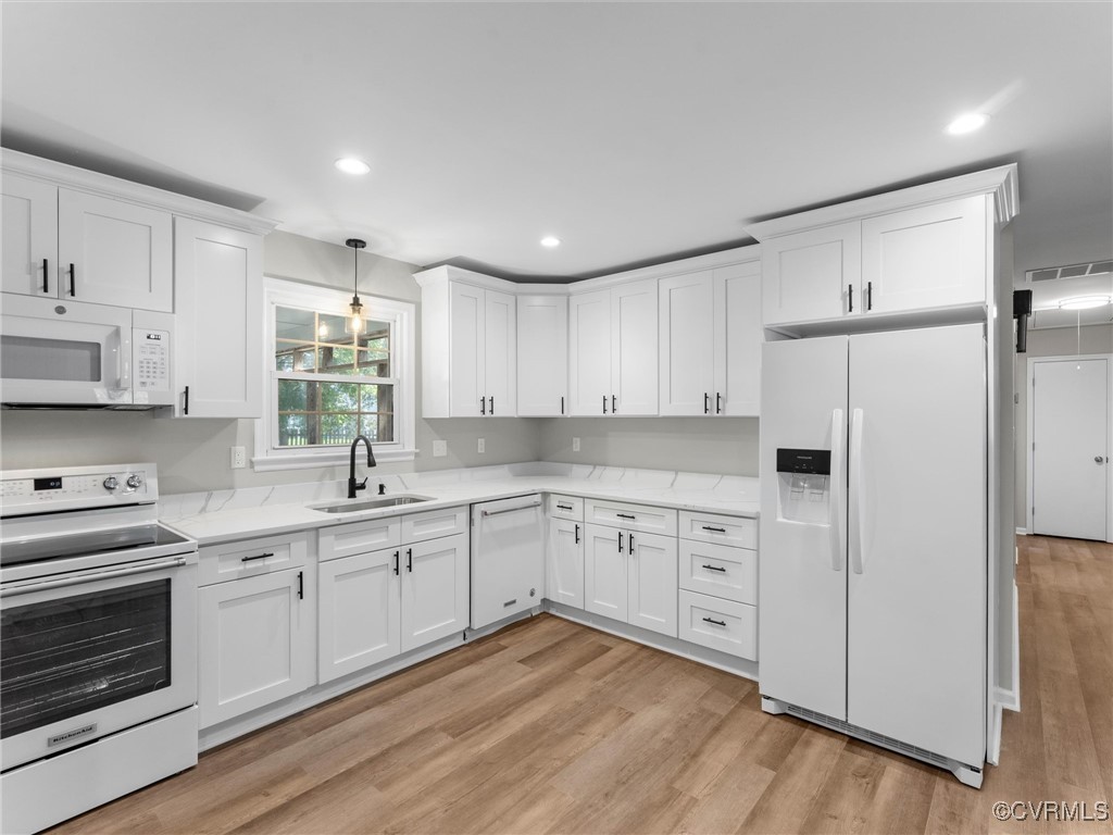 3918 Seamist Road Chester, VA 23831 - Photo 15 of 36 a kitchen with white cabinets and white appliances