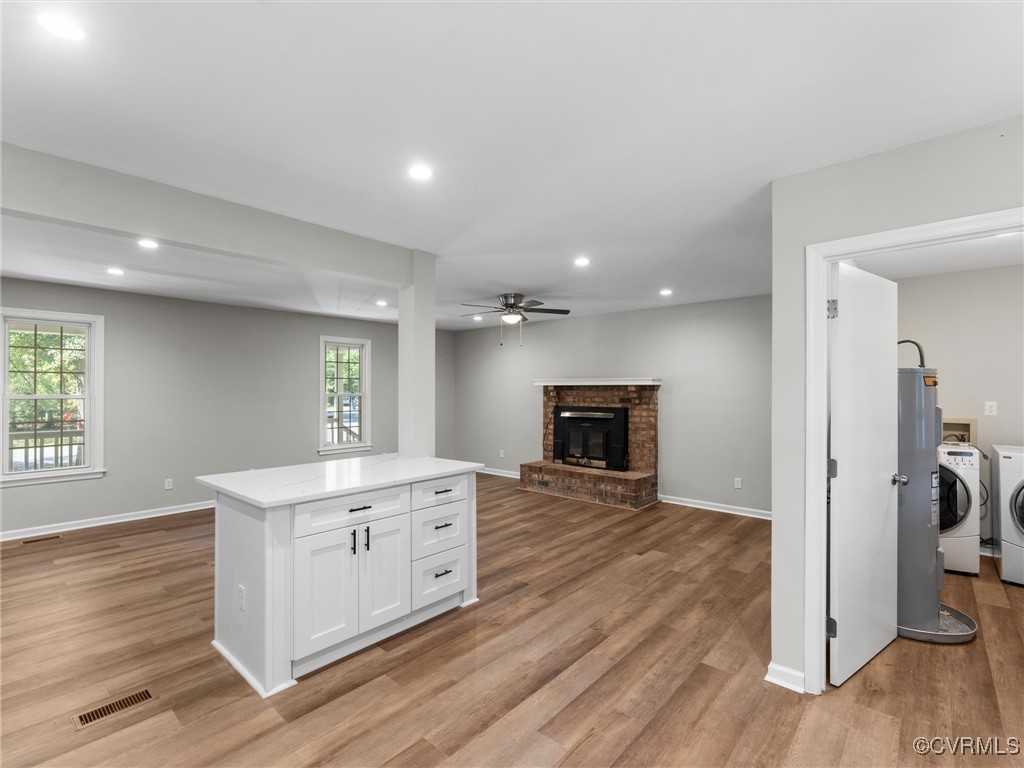 3918 Seamist Road Chester, VA 23831 - Photo 17 of 36 a view of a kitchen with a sink a fireplace and wooden floor