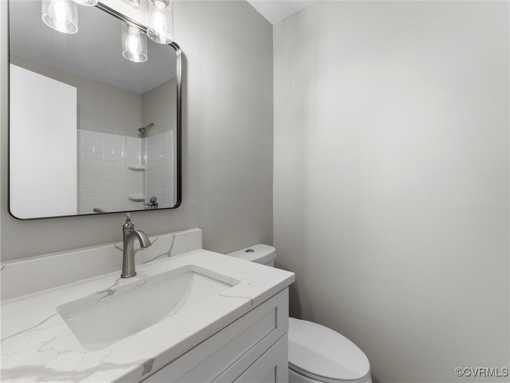 3918 Seamist Road Chester, VA 23831 - Photo 24 of 36 a bathroom with a sink a toilet and mirror