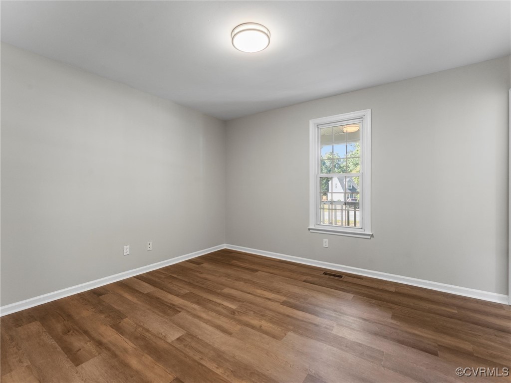 3918 Seamist Road Chester, VA 23831 - Photo 25 of 36 a view of an empty room with wooden floor and a window