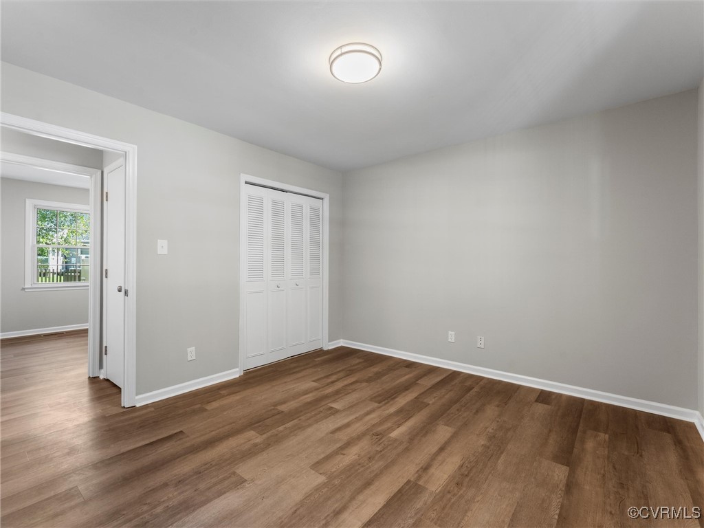 3918 Seamist Road Chester, VA 23831 - Photo 26 of 36 an empty room with wooden floor and windows
