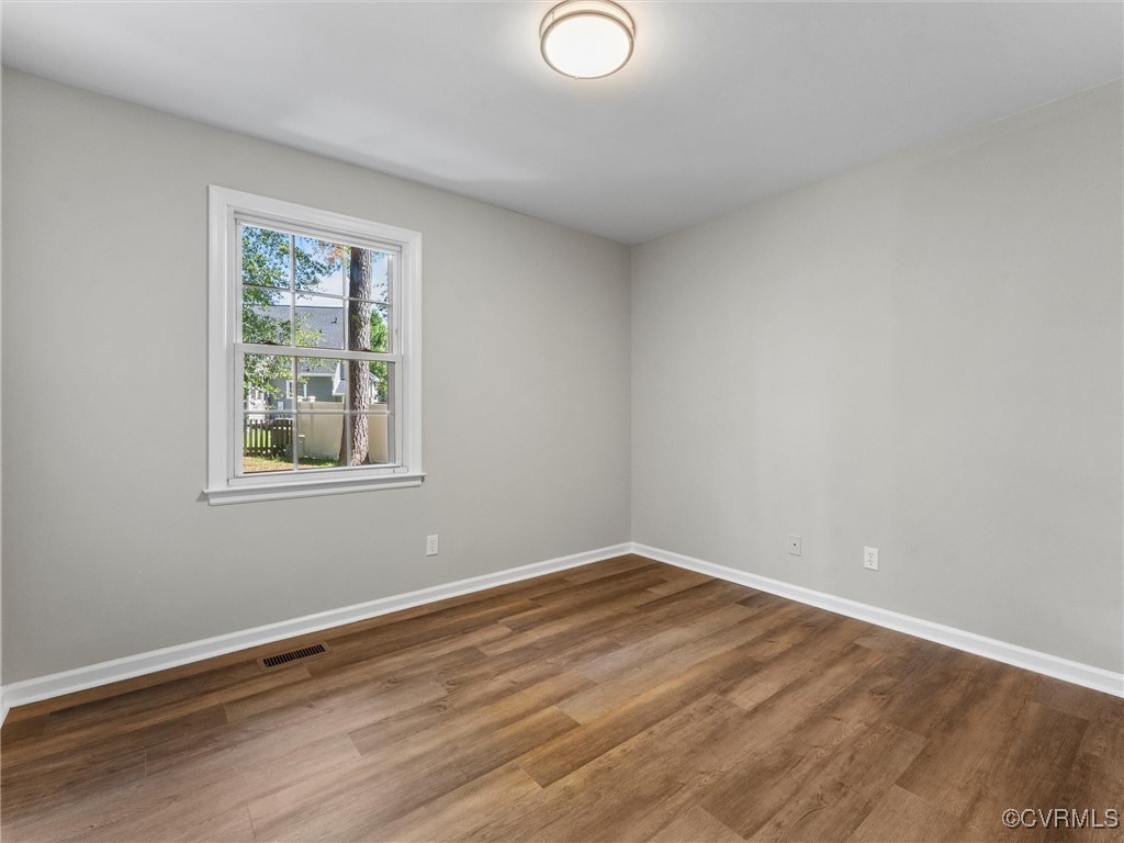 3918 Seamist Road Chester, VA 23831 - Photo 28 of 36 a view of an empty room with wooden floor and a window