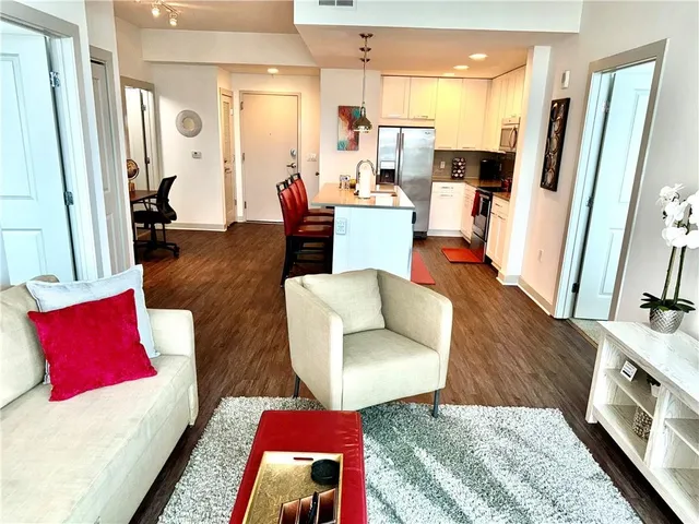 a living room with furniture and a wooden floor