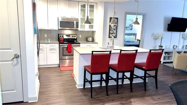 a dining room with furniture and wooden floor