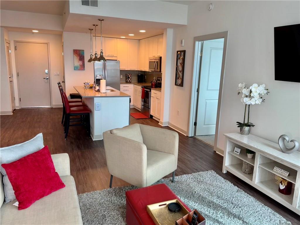 3382 Peachtree Road Northeast, Unit S12 Atlanta, GA 30326 - Photo 21 of 29 a living room with furniture and a flat screen tv