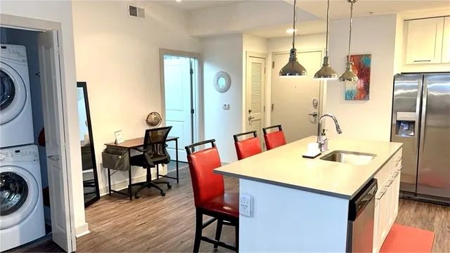 a kitchen with a sink a table and chairs