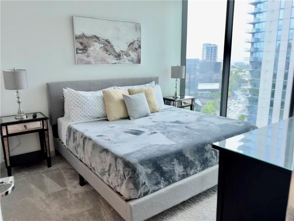 3382 Peachtree Road Northeast, Unit S12 Atlanta, GA 30326 - Photo 25 of 29 a bedroom with a bed and a painting on the wall