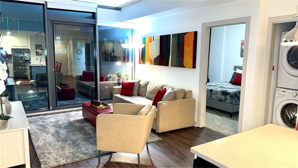 3382 Peachtree Road Northeast, Unit S12 Atlanta, GA 30326 - Photo 4 of 29 a living room with furniture and a lamp