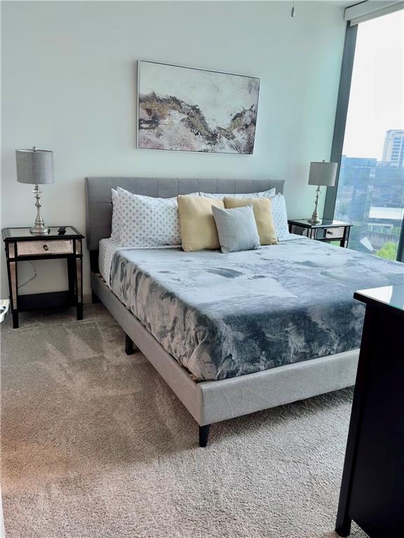 3382 Peachtree Road Northeast, Unit S12 Atlanta, GA 30326 - Photo 6 of 29 a spacious bedroom with a bed and a window