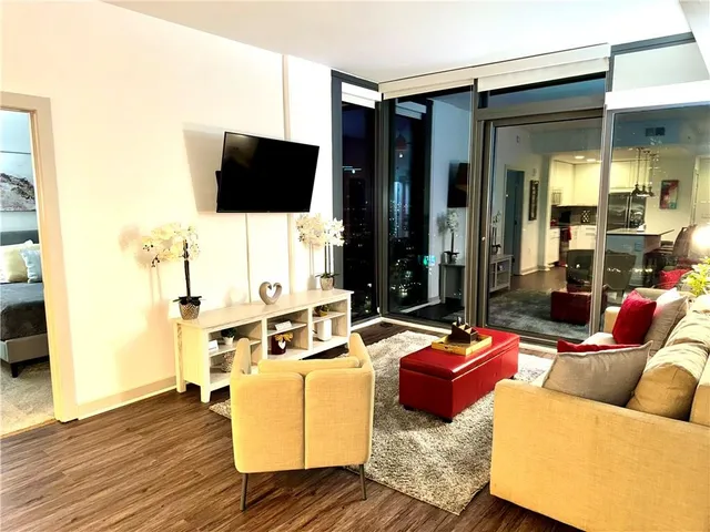 a living room with furniture and a flat screen tv