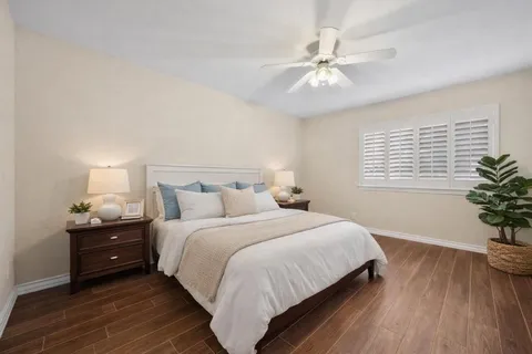 a bedroom with a bed and a potted plant