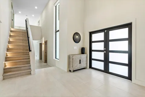 a spacious bathroom with a double vanity sink a mirror and bathtub