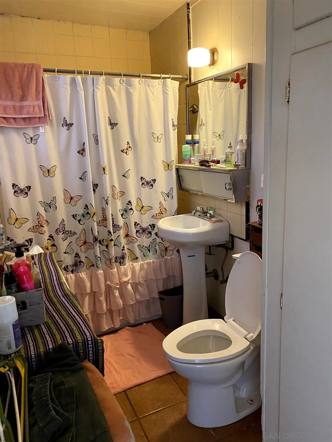 8243 Sunset Road Lakeside, CA 92040 - Photo 8 of 9 a bathroom with a toilet sink and mirror