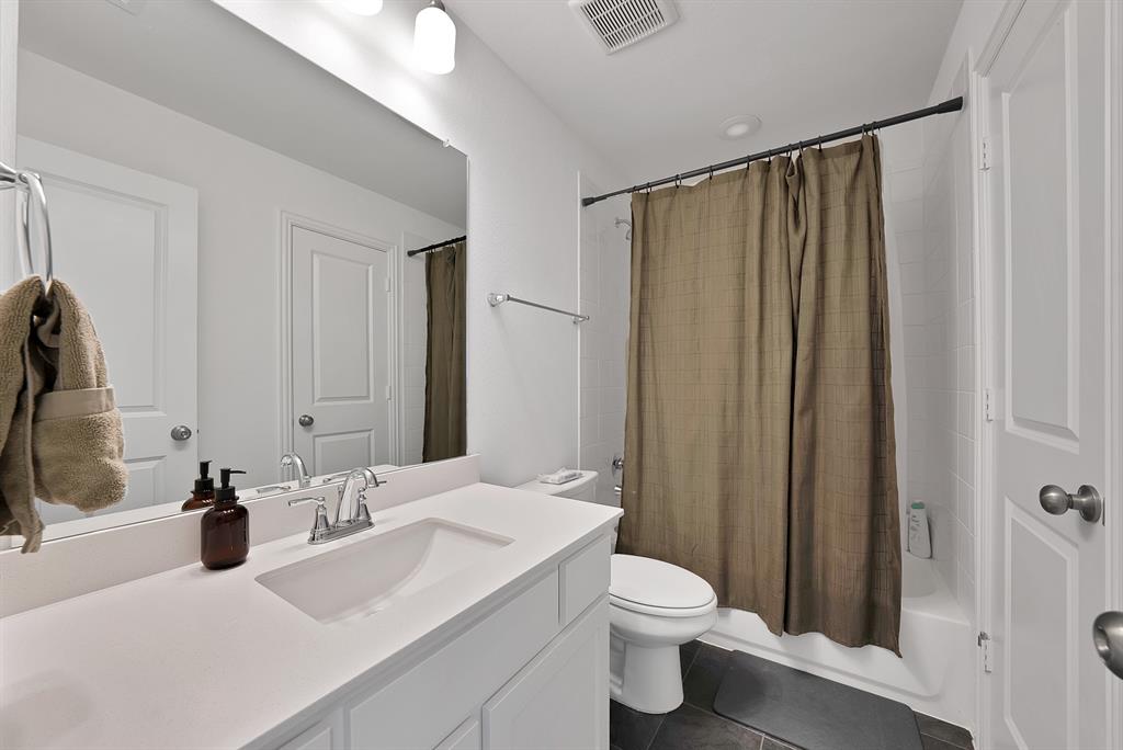 5012 Triadic Lane Prosper, TX 75078 - Photo 31 of 38 Bathroom vanity featuring an integrated sink, polished chrome faucet, and expansive wall mirror