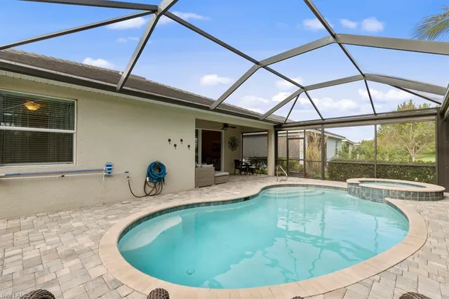 a view of a swimming pool with a lounge chair