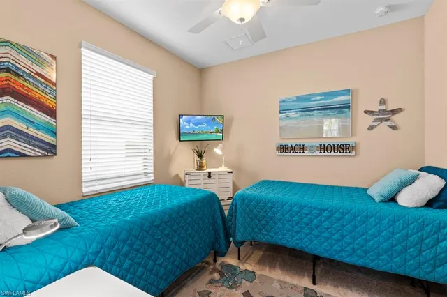 a bedroom with 2 bed and a window