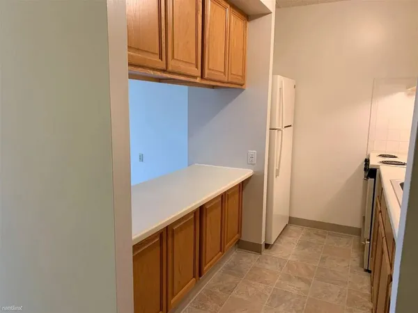 a view of storage and utility room with wooden floor