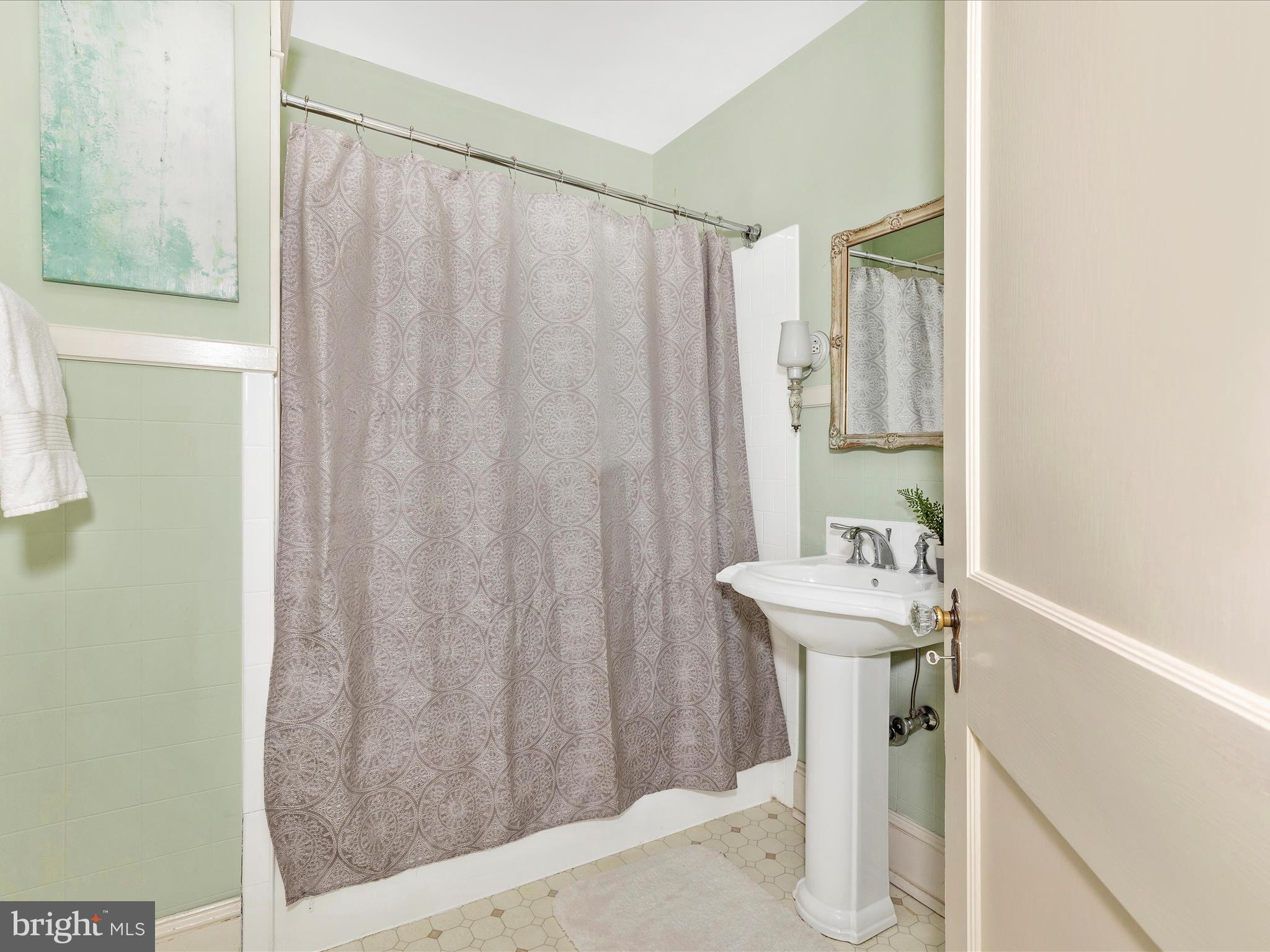 640 Wilson Place Frederick, MD 21702 - Photo 22 of 43 a bathroom with a sink a mirror and a shower curtain