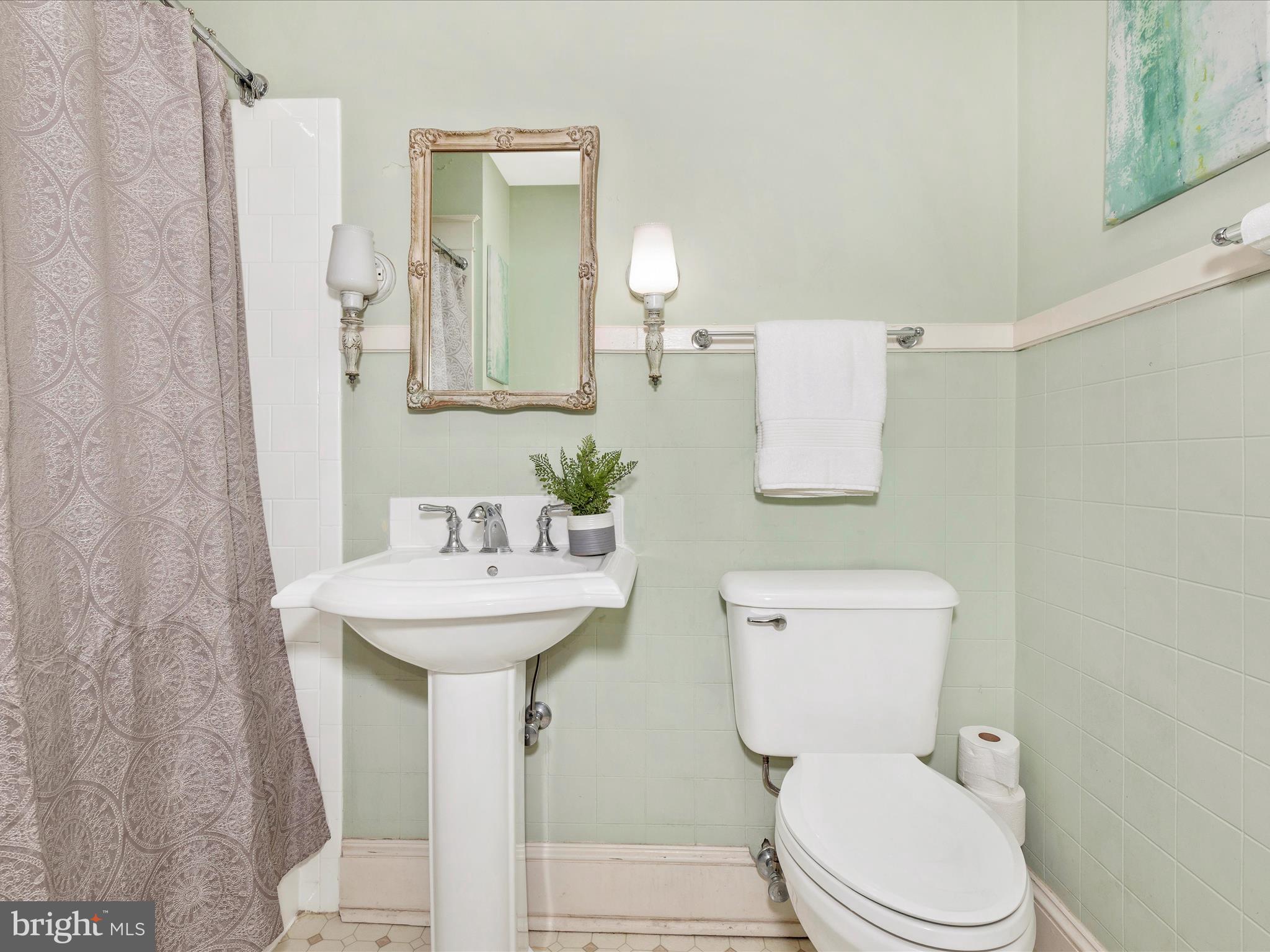 640 Wilson Place Frederick, MD 21702 - Photo 23 of 43 a bathroom with a toilet sink and mirror