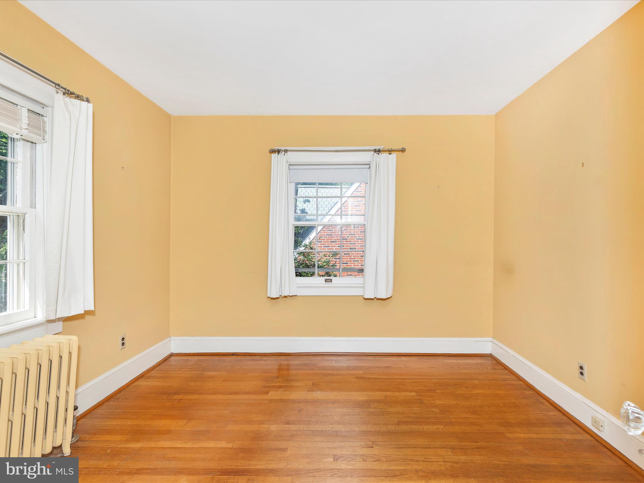 640 Wilson Place Frederick, MD 21702 - Photo 27 of 43 a view of an empty room with wooden floor and a window