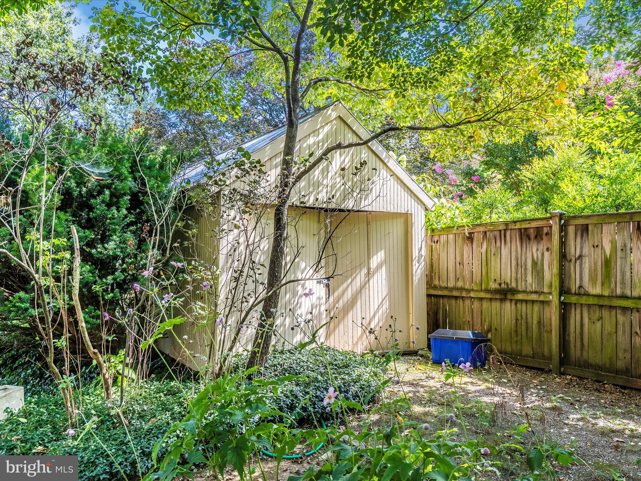 640 Wilson Place Frederick, MD 21702 - Photo 38 of 43 a view of a backyard with plants and wooden fence