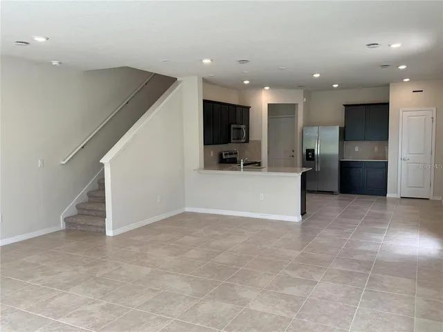 a view of a big room with kitchen view and living room