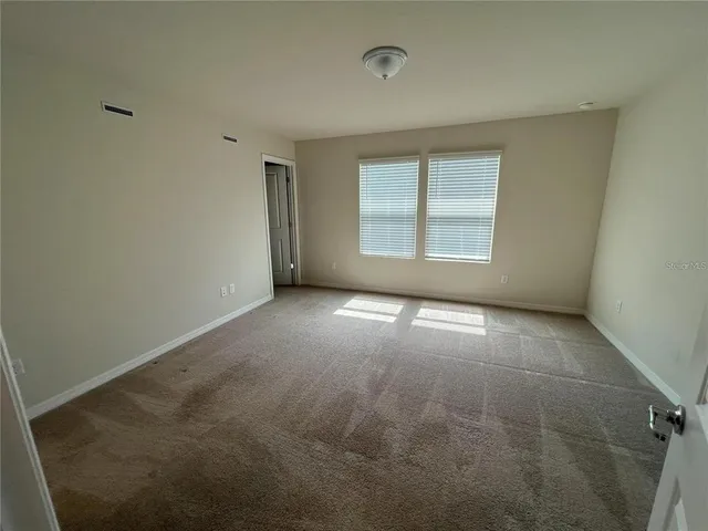 an empty room with a empty space and windows
