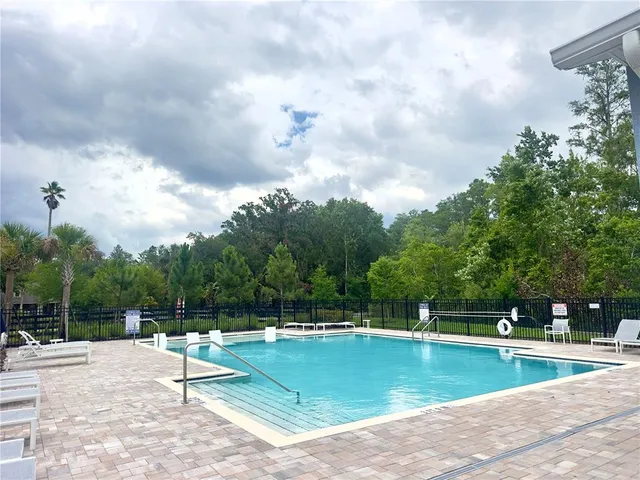 a view of a swimming pool with a yard