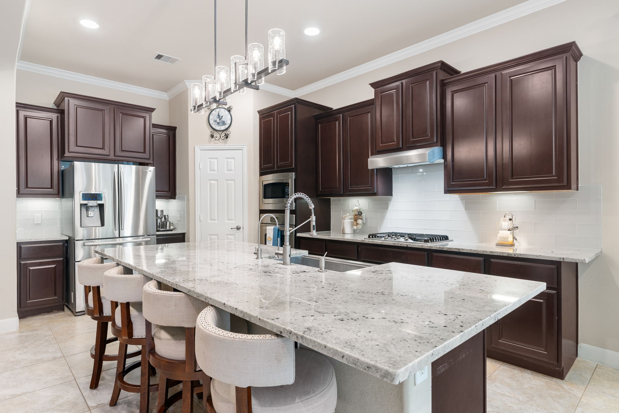 11 Pintuck Place Spring, TX 77389 - Photo 13 of 40 a kitchen with granite countertop a table chairs stainless steel appliances and cabinets