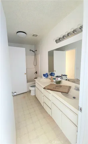 a bathroom with a double vanity sink mirror and toilet