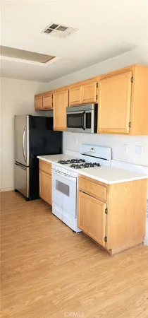 a kitchen with stainless steel appliances granite countertop a stove and a refrigerator
